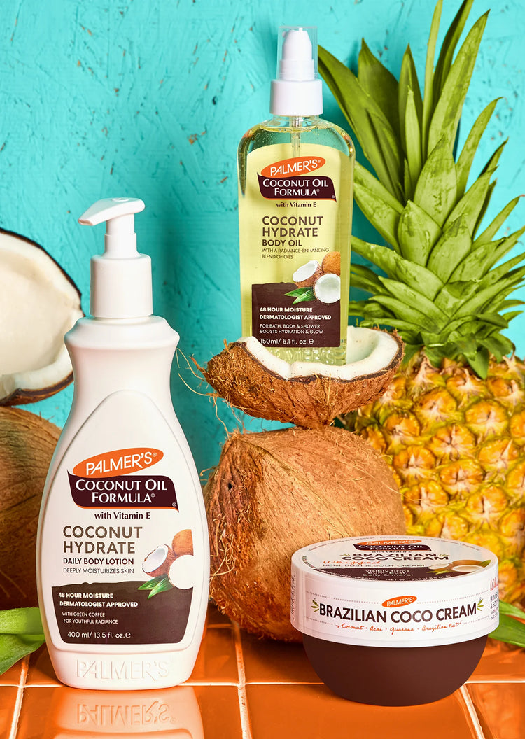 Palmer's Coconut Oil Formula products including lotion, body oil, and cream with a pineapple and coconut on a blue background.